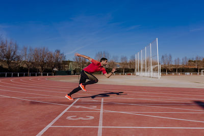 Side view of athlete running on sports track