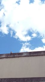 Buildings against cloudy sky