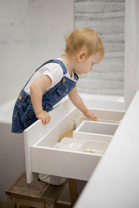 Side view of boy playing with toy blocks