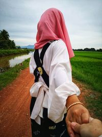 Girl holding hand of boy while traveling in remote location