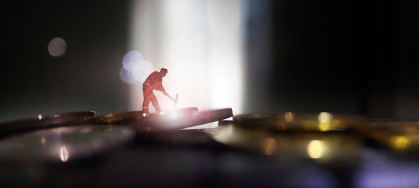 Person standing on illuminated table