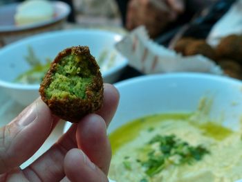 Cropped image of hand holding food