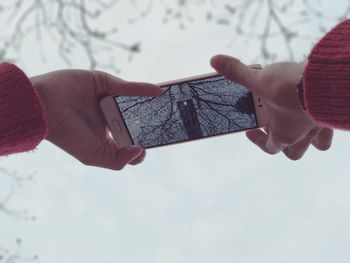 Close-up of hand touching smart phone