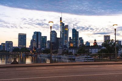 View of city buildings against cloudy sky