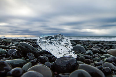 Rocks on beach against sky