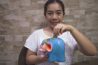 Portrait of a smiling girl holding balloons