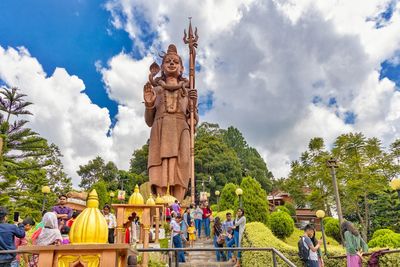 Group of people in temple against sky
