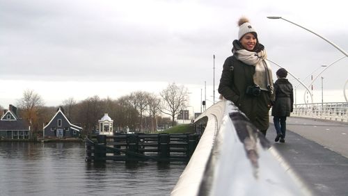 Man standing on footbridge in winter