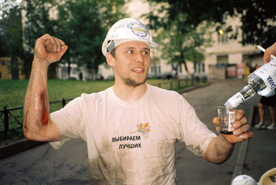 Portrait of man standing in city