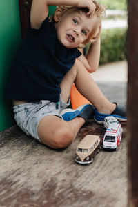 High angle view of cute boy sitting on table