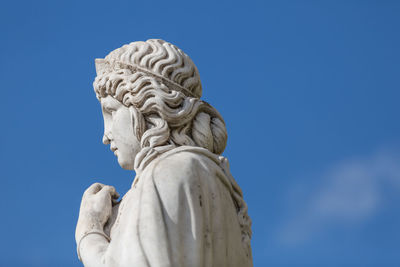 Low angle view of statue against blue sky