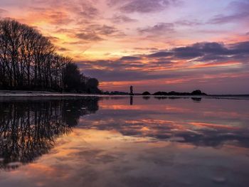 Scenic view of lake against orange sky