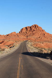 Scenic view of desert against clear blue sky