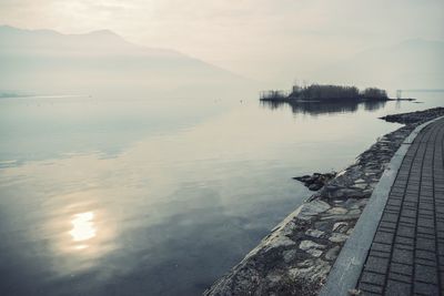 Scenic view of lake against sky during sunset