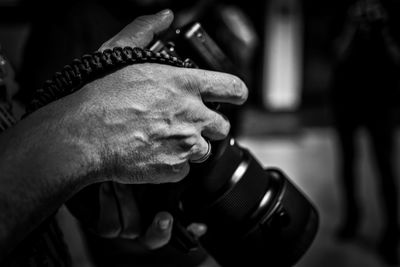 Close-up of man photographing with camera