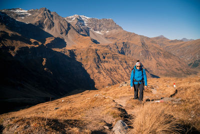 Rear view of man on mountains against sky