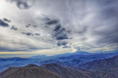 Scenic view of mountains against dramatic sky