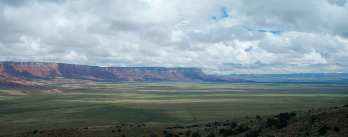 Scenic view of mountains against cloudy sky