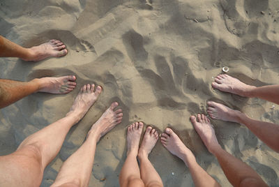 Ten feet of family of five on the sandy beach 10