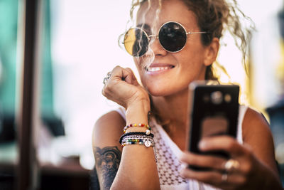 Smiling woman using mobile phone