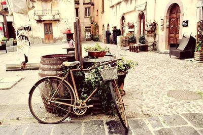 Bicycle on street amidst buildings in city