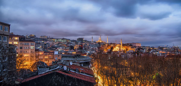 Illuminated cityscape against sky