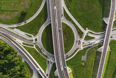 Cars moving on transport road junction in city, aerial view