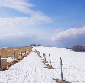 Scenic view of snow covered landscape against sky