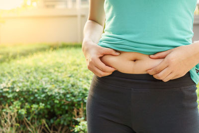 Midsection of woman holding stomach