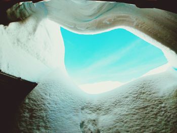 Low angle view of snow covered mountain against sky