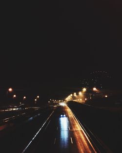 Illuminated road in city at night