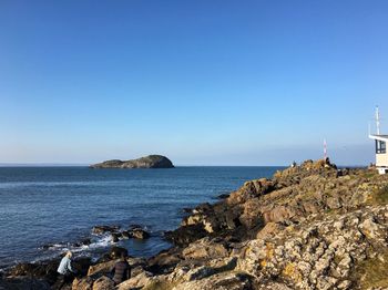 Scenic view of sea against clear blue sky