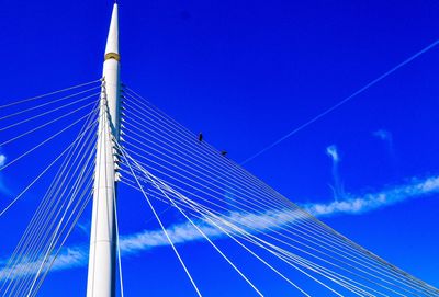 Low angle view of vapor trail against blue sky