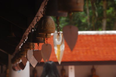 Low angle view of bells hanging on ceiling of building