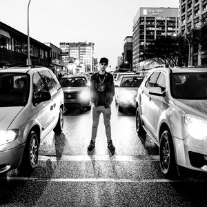 View of vehicles on road along buildings