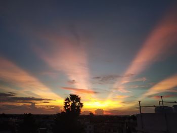 Silhouette buildings against sky during sunset