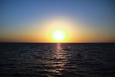 Scenic view of sea against clear sky during sunset