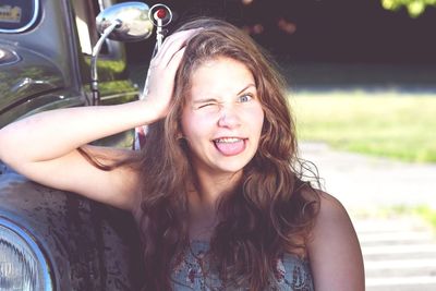 Portrait of teenage girl sticking out tongue