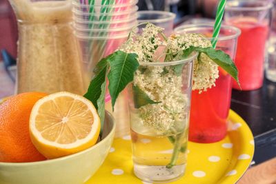 Close-up of fruits with drink on table