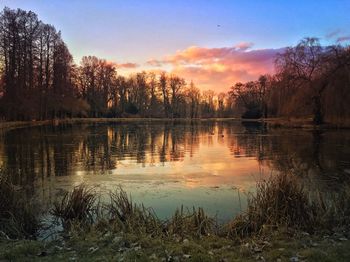 Scenic view of lake against sky at sunset