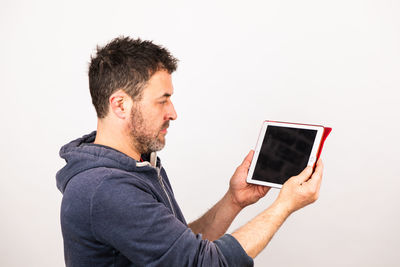 Side view of man using smart phone against white background