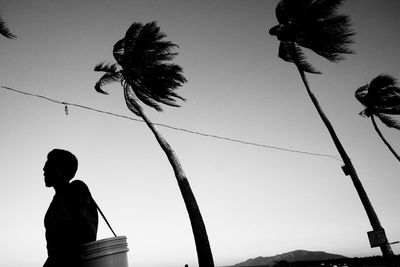 Low angle view of silhouette of man against sky