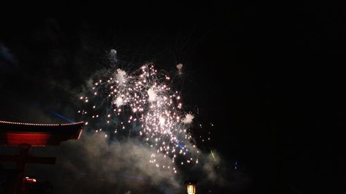 Low angle view of firework display at night