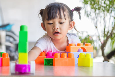 Portrait of cute girl playing with toy