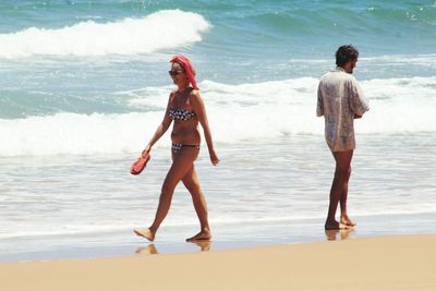 Full length of woman standing on beach