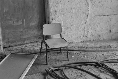 Empty chair against wall