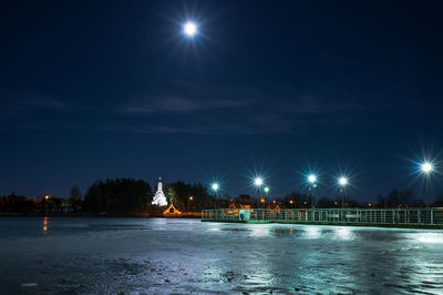 Scenic view of illuminated lake against sky at night during winter
