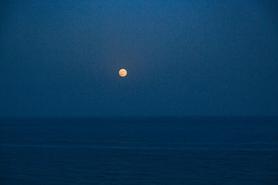 Scenic view of sea against clear sky at night