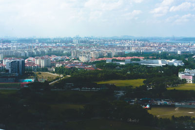 High angle view of buildings and trees against sky