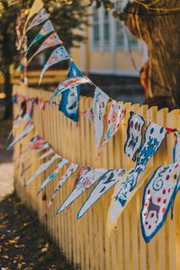 Close-up of buntings hanging on fence